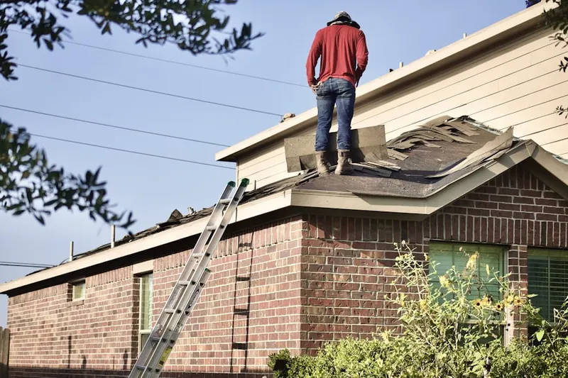 Professional roofer working on a residential roof in Decatur